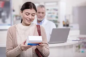 Medicament Prints: Pleased female client checking drug
