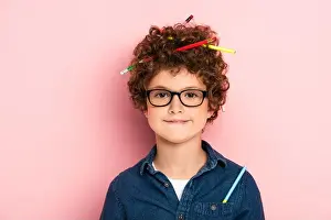Look At Camera Prints: pleased kid in glasses with color pencils in curly hair on pink