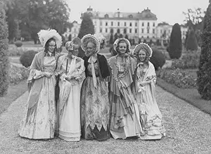 Coiffure Prints: Poke bonnets. A group of five young women in the park of Drottning holm castle