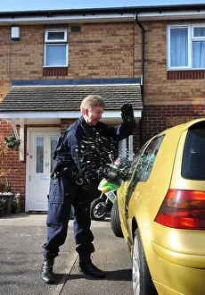Lockdown Prints: Police officers from the operational team break into a suspects car in Gloucester where one of a series of dawn raids