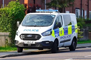 Ford Prints: A Police van from West Yorkshire Police parked outside a property in Swillington