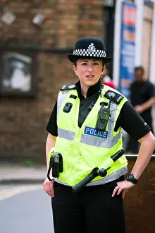 Enforcement Prints: Police woman in Ross on Wye closing a road for the annual carnival