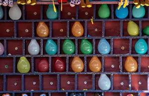Throw Prints: pop a balloon with a dart and win a prize at this carnival game both