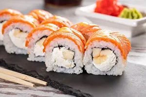 Flavour Prints: Popular food. Set of Philadelphia sushi on black concrete plate on table