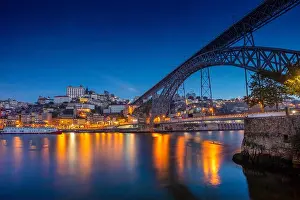 Porto, Portugal. Cityscape image of Porto, Portugal with reflection of the city in the Douro River and the Luis I Bridge during twilight blue hour