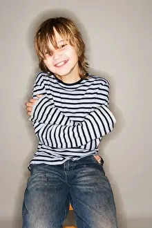 Disheveled Prints: PORTRAIT OF 11 YEAR OLD BOY SITTING ON STOOL SMILING HAPPY ARMS CROSSED