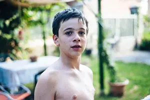 Weight Loss Prints: portrait of a 13-year-old boy in summer shirtless in his home garden