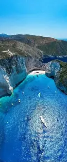 Noon Prints: Portrait aerial drone shot of Zakynthos Navagio beach with yachts and cruise ship in Ionian sea in Greece