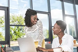 Coworkers Prints: portrait of african american businesspeople working together on laptop in office