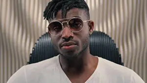 Goggles Prints: Portrait African American guy man ethnic male putting on sunglasses glasses wearing looking at camera sitting