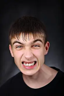 Worry Prints: Portrait of Angry Young Man on the Black Background