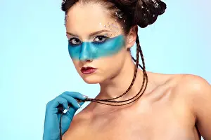 Sensuality Prints: portrait of beautiful girl with blue stripe facial bodyart and fantasy hair-do with several thin braids