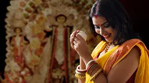 Well Dressed Prints: Portrait of a beautiful Married Bengali woman holding conch shell