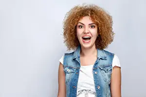 Curly Hair Prints: Portrait of beautiful surprised curly mixed race girl in casual style