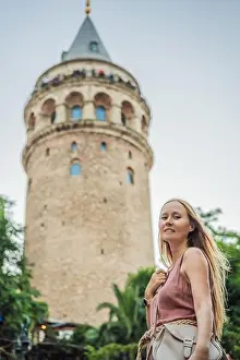 Portrait of beautiful woman tourist with view of Galata tower in Beyoglu, Istanbul, Turkey. Turkiye
