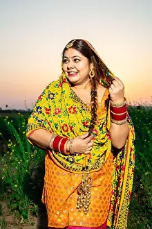 Punjab Prints: Portrait of beautiful young indian punjabi woman wearing colorful traditional standing at agriculture field outdoor