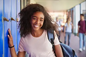 Schoolchild Prints: Portrait of black teenage girl by lockers in school corridor