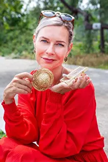 Dreaming Prints: portrait of blond woman holding miniature sun chair and straw hat