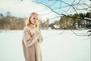 Miracle Prints: Portrait of a blonde girl in a sweater in a snowy forest on a cold day