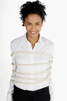 Satisfied Prints: Portrait of a businesswoman tied up with rope and smiling
