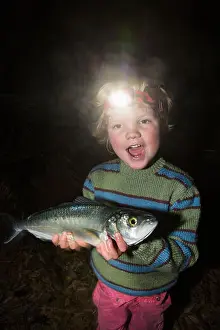 Three Quarter Prints: Portrait of cheerful boy wearing headlamp fish in forest