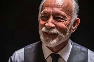 Wrinkles Prints: Portrait of cheerful senior man on black background