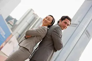 Three Quarter Prints: Portrait of two confident businesspeople standing with their arms crossed in the city