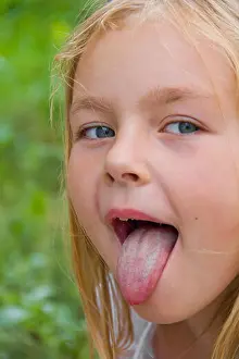 Portrait of cute girl with put out tongue