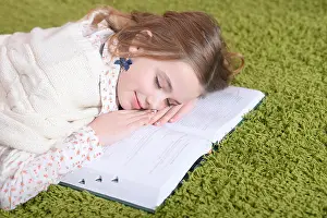 Definition Prints: Portrait of cute tired schoolgirl sleeping at home