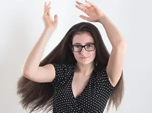 Long Haired Prints: Portrait of a Dancing Bespectacled Long-haired Brunette Teen Girl with Hands in the Air