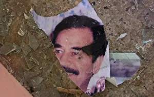 Dictator Prints: a portrait of deposed iraqi dictator saddam hussein is torn