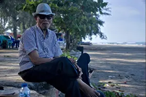 Pine Tree Prints: Portrait of an Elderly Man Sitting Under Pine Trees with a Peaceful Expression