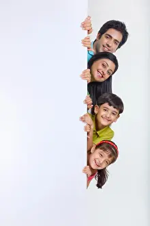 20 25 Prints: Portrait of family peeking behind white board