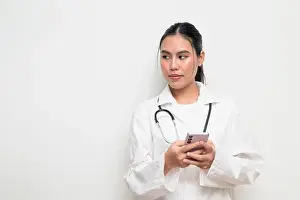 Texting Prints: Portrait of a female healthcare professional in a white medical uniform with a stethoscope