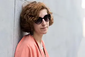 Bruxelles Prints: Portrait of a girl next door with red hair posing against a grey rough wall