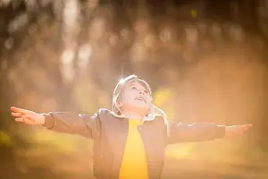 Enjoy Prints: Portrait of happy child wearing pilot costume against yellow leaves background