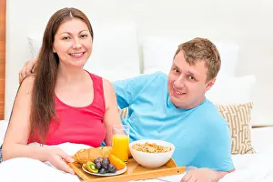 Pajamas Prints: Portrait of a happy couple with breakfast on a tray