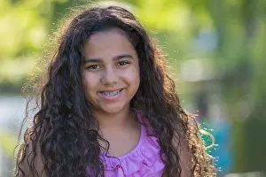Disability Prints: Portrait of happy Hispanic teen girl with braces
