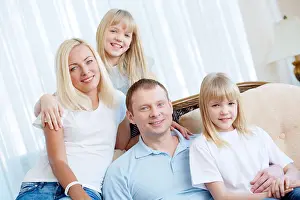Embracing Prints: Portrait of happy mom and dad bonding with their twin kids