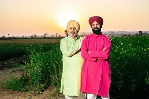 Two Person Prints: Portrait of happy punjabi srdar father and son wearing kurta and pagdi turban standing together at agriculture field