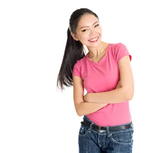 Ponytail Prints: Portrait of happy young Asian woman in pink shirt and jeans with ponytail hair