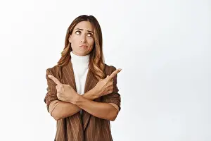 Puzzled Prints: Portrait of indecisive woman pointing sideways with confused face