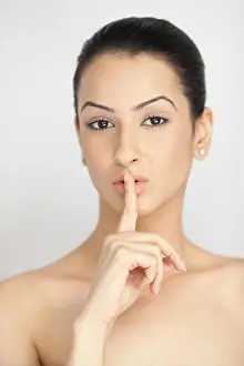 Silence Prints: Portrait of an Indian young woman with a finger on lips
