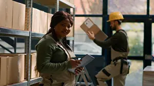 Assistant Prints: Portrait of joyful head of logistics in warehouse holding tablet
