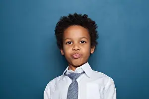Schoolboy Prints: Portrait of little funny black kid boy on blue background