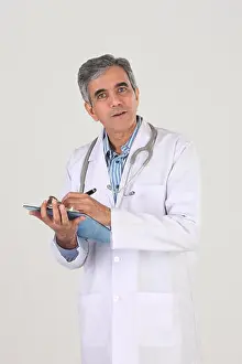 Grown Up Prints: Portrait of a male doctor writing prescription