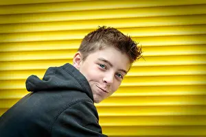 Hoodie Prints: portrait of a male teenager with yellow rolling shutter in background