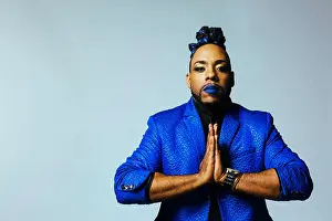 Make Up Prints: Portrait of a man in blue jacket and blue lips and hands together in prayer