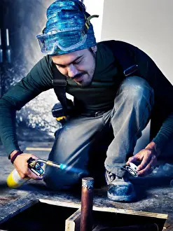 20 30 Prints: Portrait of man contractor worker with a blow torch capping a pipe doing plumbing