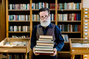 Tutor Prints: Portrait of positive smart old bearded man in dark shirt and leather vest